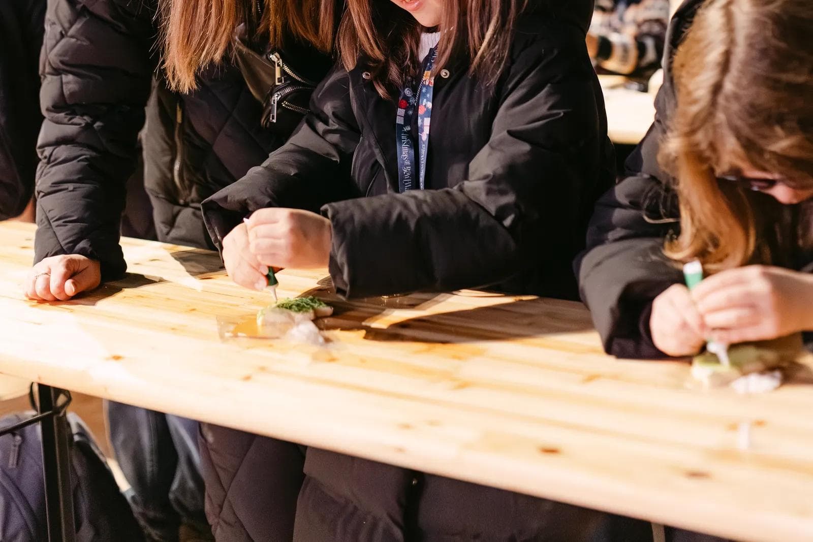 A mother and daughter decorating festive shortbread biscuits in Rosemary's Bakery