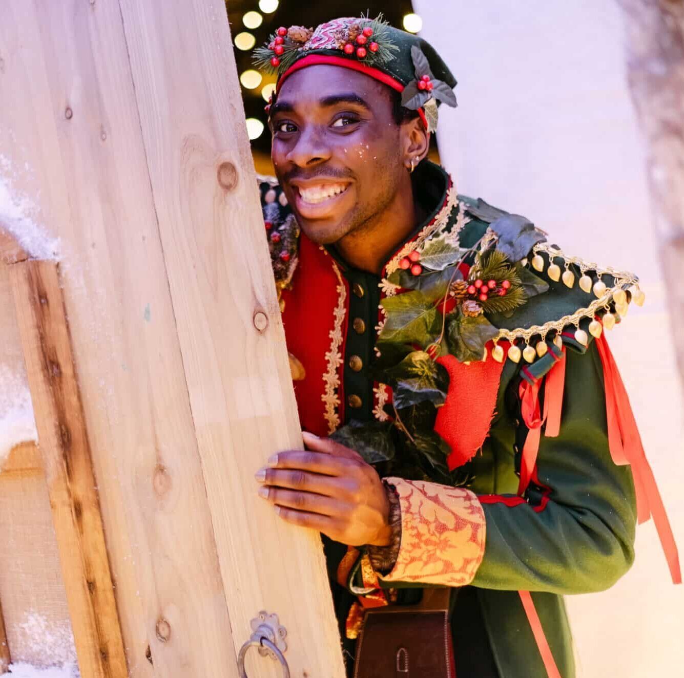 Cheerful Elf Greeting Families at Christmas at Bewl Water before seeing Santa in his Grotto