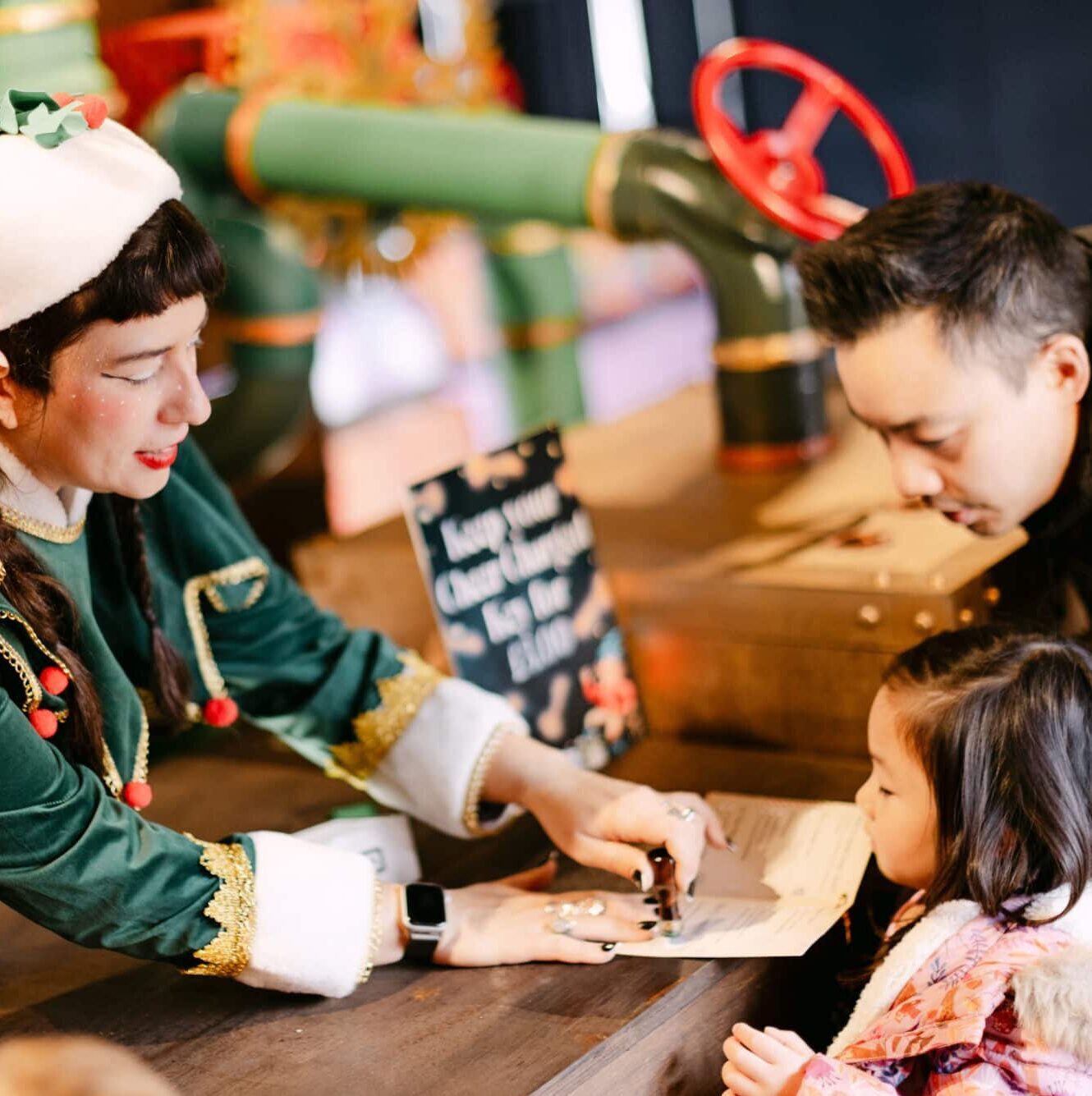 Child receiving an official elf stamp during Santa’s Quest at Christmas at Bewl Water, a fun interactive Christmas event for families in Kent.