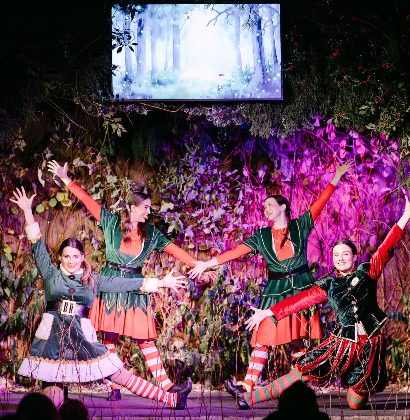 Live Christmas elf performance on stage at Christmas at Bewl Water, featuring festive dancing and storytelling as part of Kent’s immersive Christmas experience.