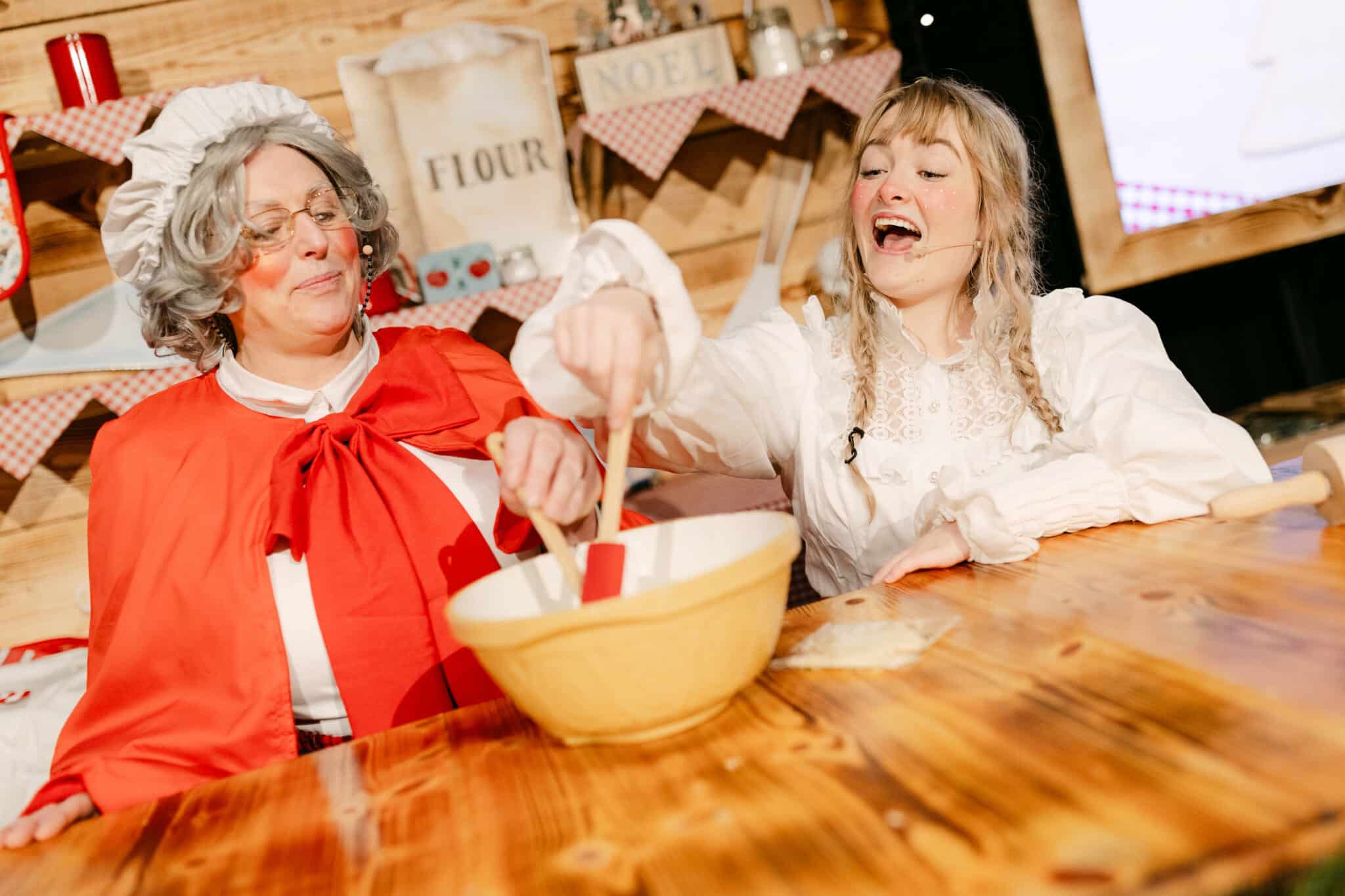 Mrs Claus leading a festive activity with children at Christmas at Bewl Water, an immersive and theatrical Christmas experience in Kent.