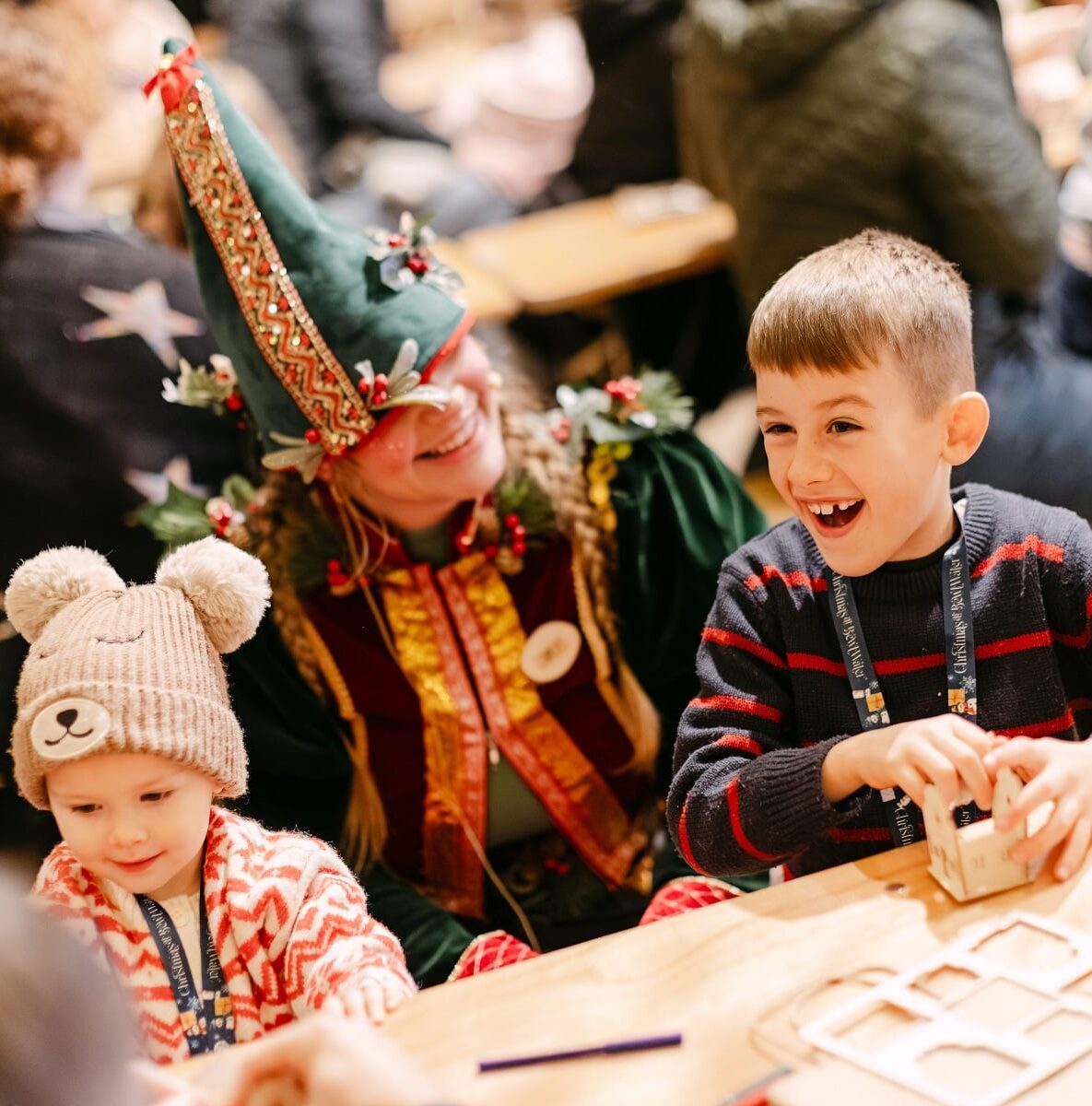 Children laughing and crafting with a festive Christmas elf at Christmas at Bewl Water, part of Kent’s magical and interactive family Christmas experience.